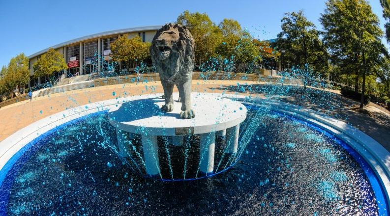 Lion statue in the middle of a waterfall 